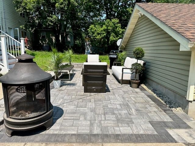 Chic Patio with Fireplace by Walker Outdoor Solutions image